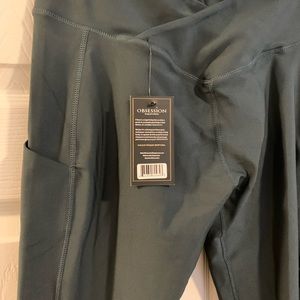 Obsession leggings size large pocket side, criss cross front